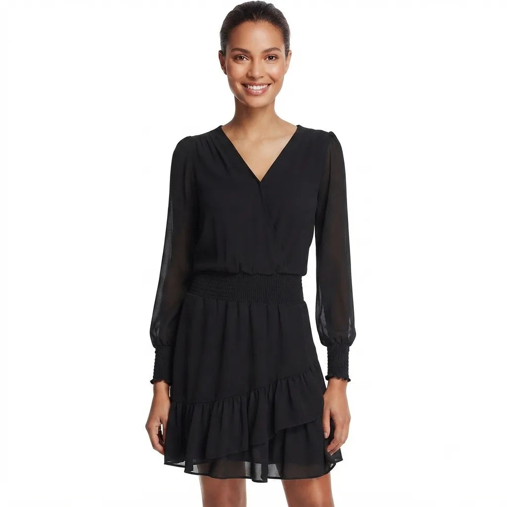 A woman modeling a black long-sleeve V-neck mini dress with sheer sleeves and a tiered skirt, photographed against a plain white background.