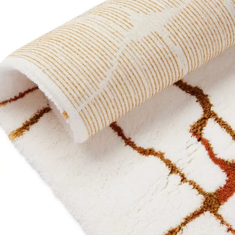 Close-up of a textured rug with geometric pattern on a white background