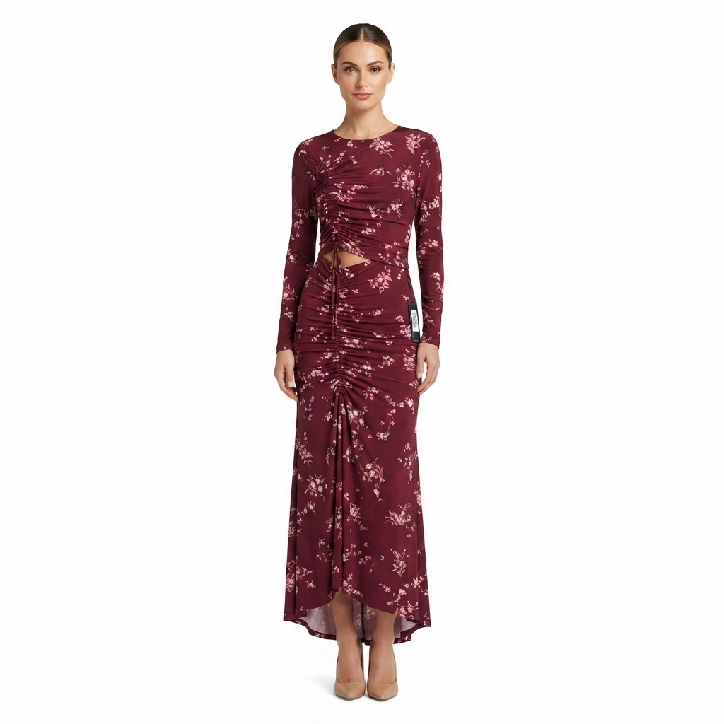 A woman modeling a long-sleeve, floor-length burgundy dress with a white floral pattern and a twisted front detail, set against a plain white background.