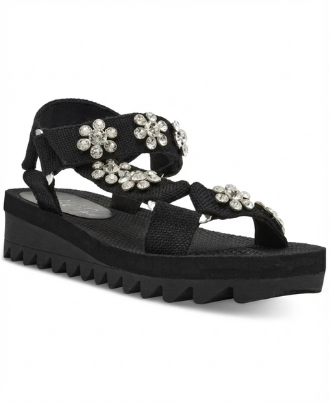 Black sandal with floral embellishments on a white background