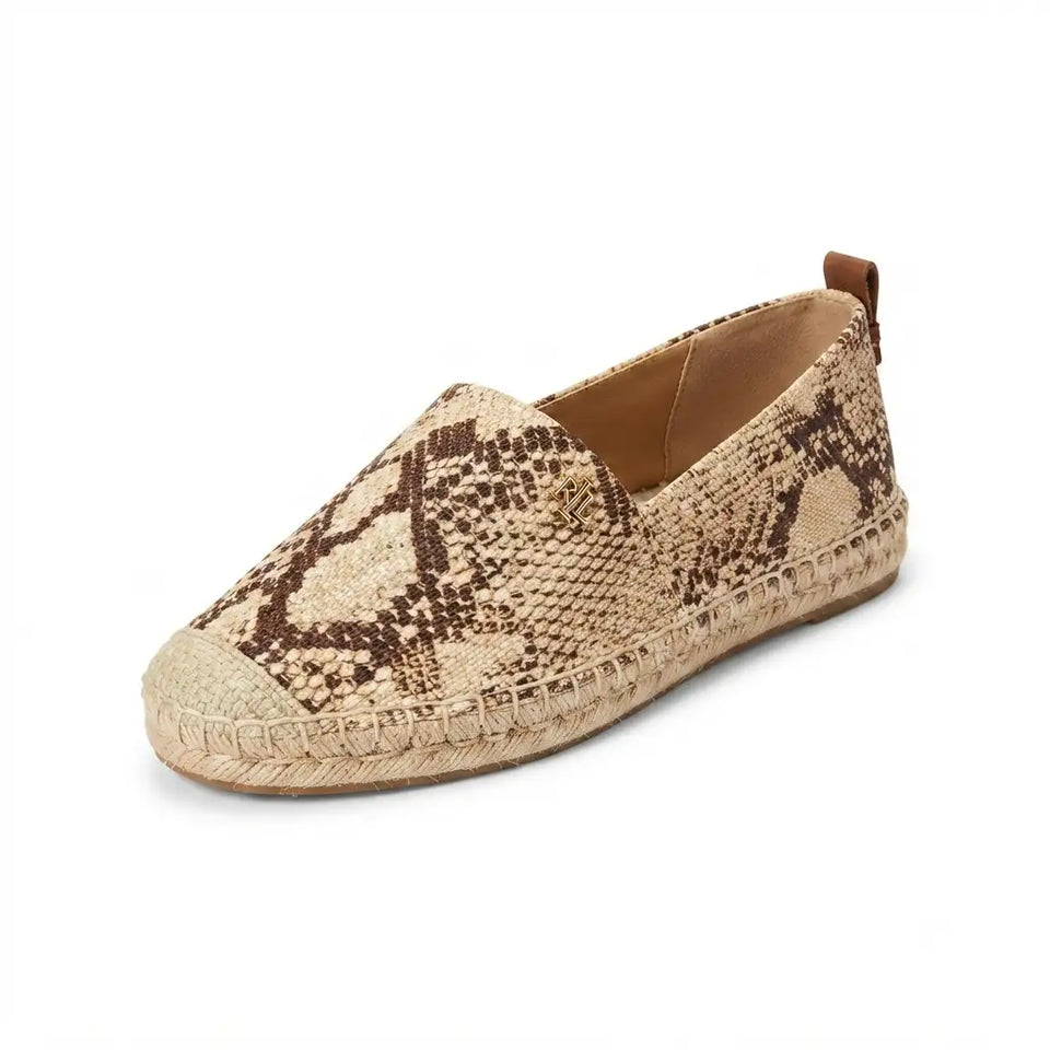 A single slip-on espadrille shoe featuring a beige and brown snakeskin pattern on the fabric upper, a braided jute sole, and a pull tab at the heel, shown against a plain white background.