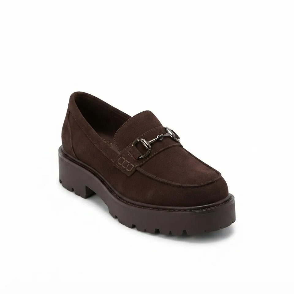 A dark brown suede loafer with a chunky platform sole and a silver horsebit detail across the vamp, shown on a plain white background.