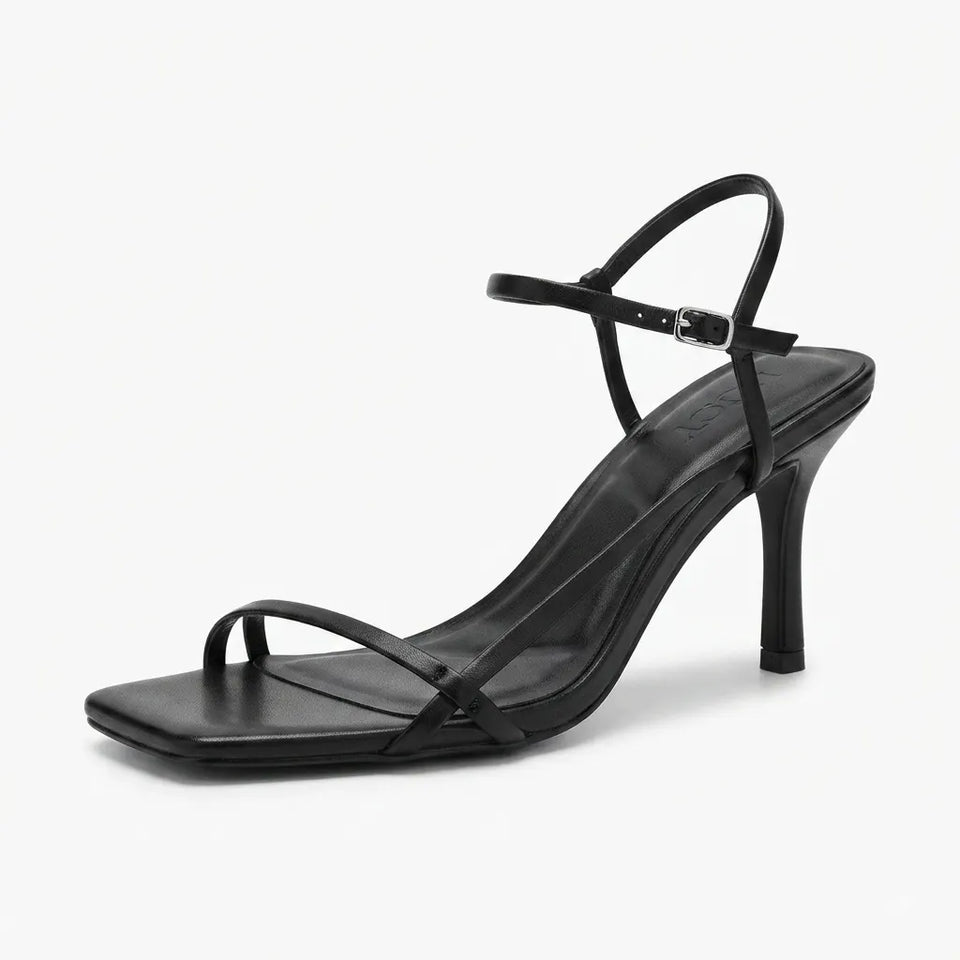 Maroon high-heeled shoes with thin straps on a white background
