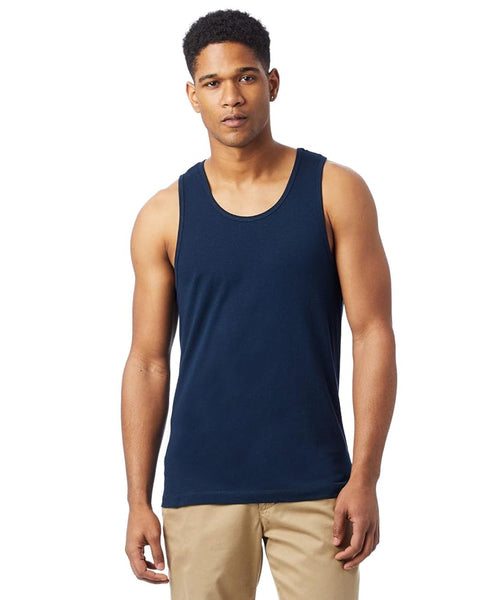 Man wearing a navy tank top and beige pants on a white background