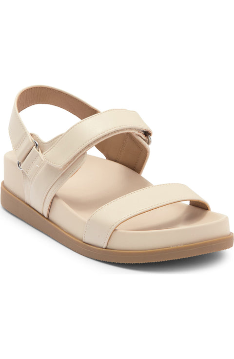 Beige sandal with cross-straps on a white background