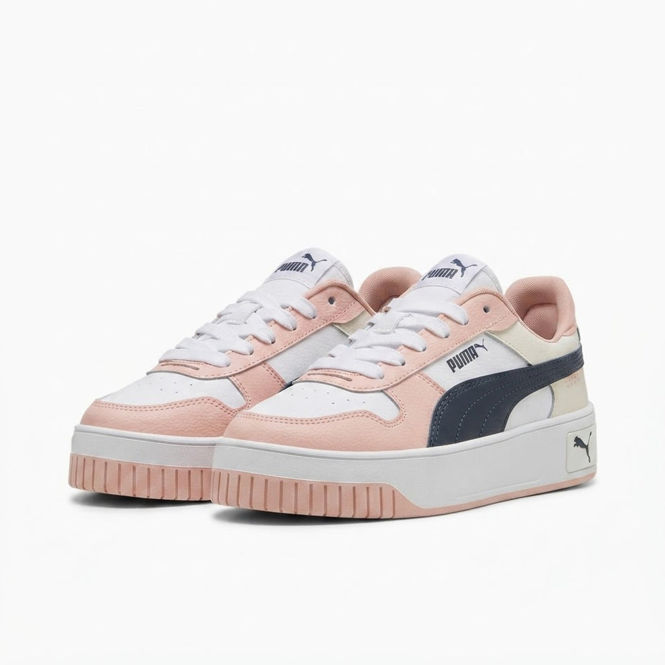 A pair of Puma platform sneakers in pastel pink, white, and navy blue, shown from a three-quarters angle on a clean white background.