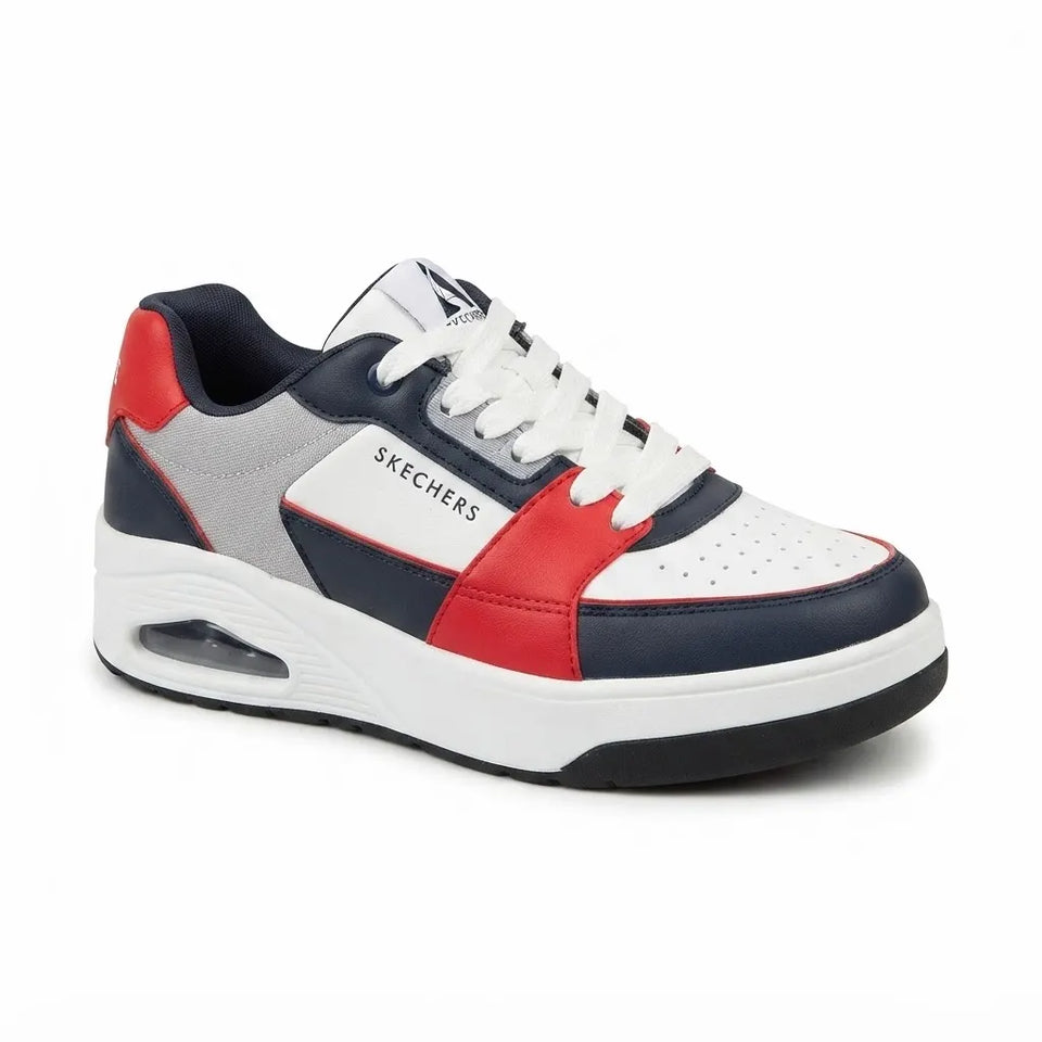 A Skechers low-top sneaker in a color-blocked design of white, navy blue, red, and gray, featuring white laces and a thick white midsole with a visible air unit.