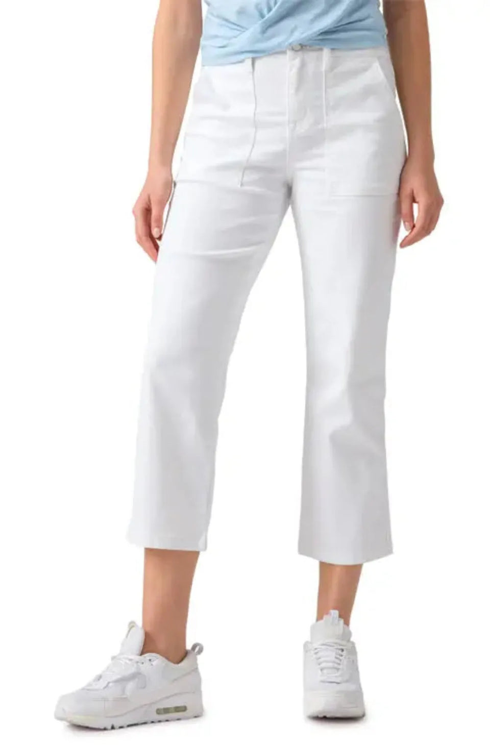 Person wearing white pants and white sneakers on a white background