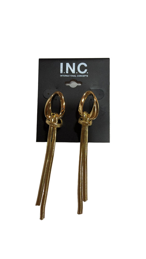Gold earrings on an INC International Concepts card against a white background