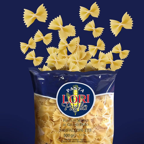 Bag of Pasta Lori Puglia with bow-shaped pasta spilling out on a blue background