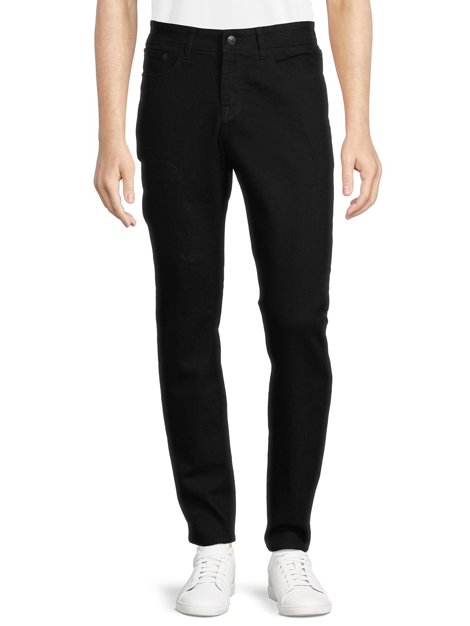 Person wearing black jeans and white sneakers on a white background