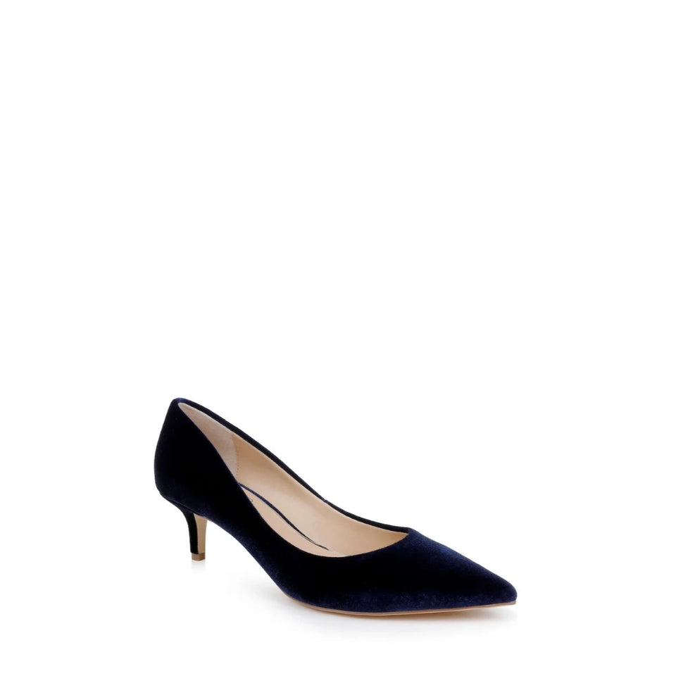 A single navy blue velvet pointed-toe pump with a kitten heel, shown from a side profile on a clean white background.