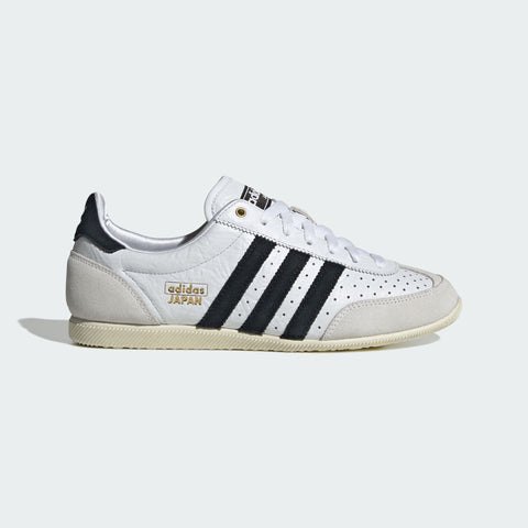 White Adidas sneaker with black stripes on a light gray background