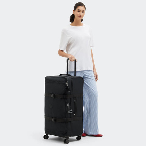 Woman holding a black suitcase on a white background
