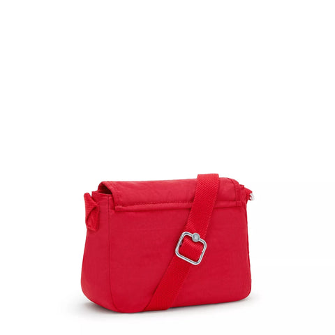 Red handbag with a silver buckle on a white background