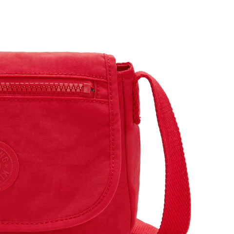 Red crossbody bag with a visible brand logo on a white background