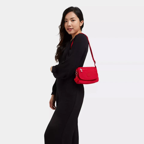 Woman carrying a red handbag on a white background