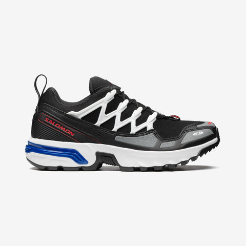 Black and white Salomon running shoe on a light gray background