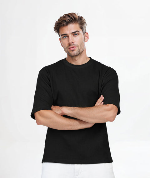 Man wearing a black t-shirt against a white background