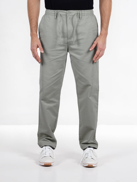 Person wearing gray pants on a white background