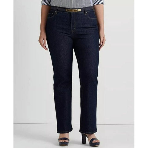 Person wearing dark blue jeans on a plain background