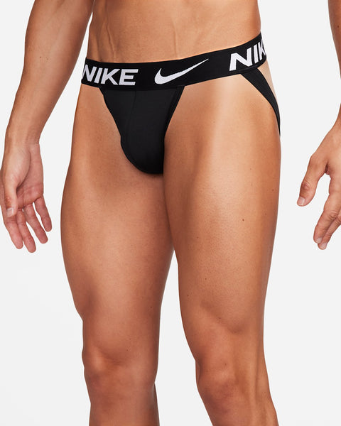 Black Nike men's briefs on a plain background