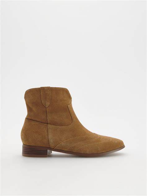 Brown suede ankle boot on a light gray background