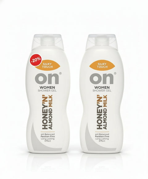 Two bottles of 'on' Women Shower Gel with honey almond milk scent on a desk.