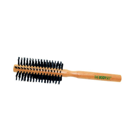 Round hairbrush with wooden handle and black bristles on a white background, branded 'The Body Set'.