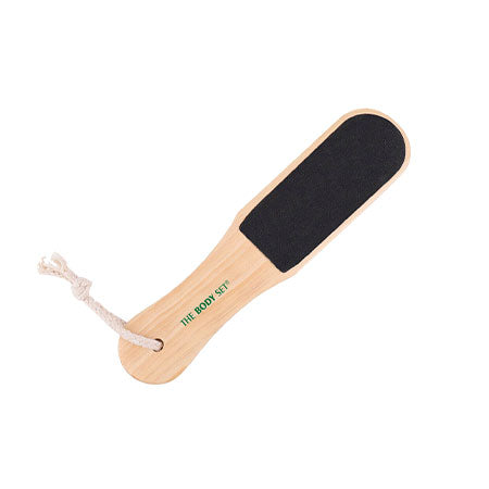 Wooden foot file with black sandpaper on a white background