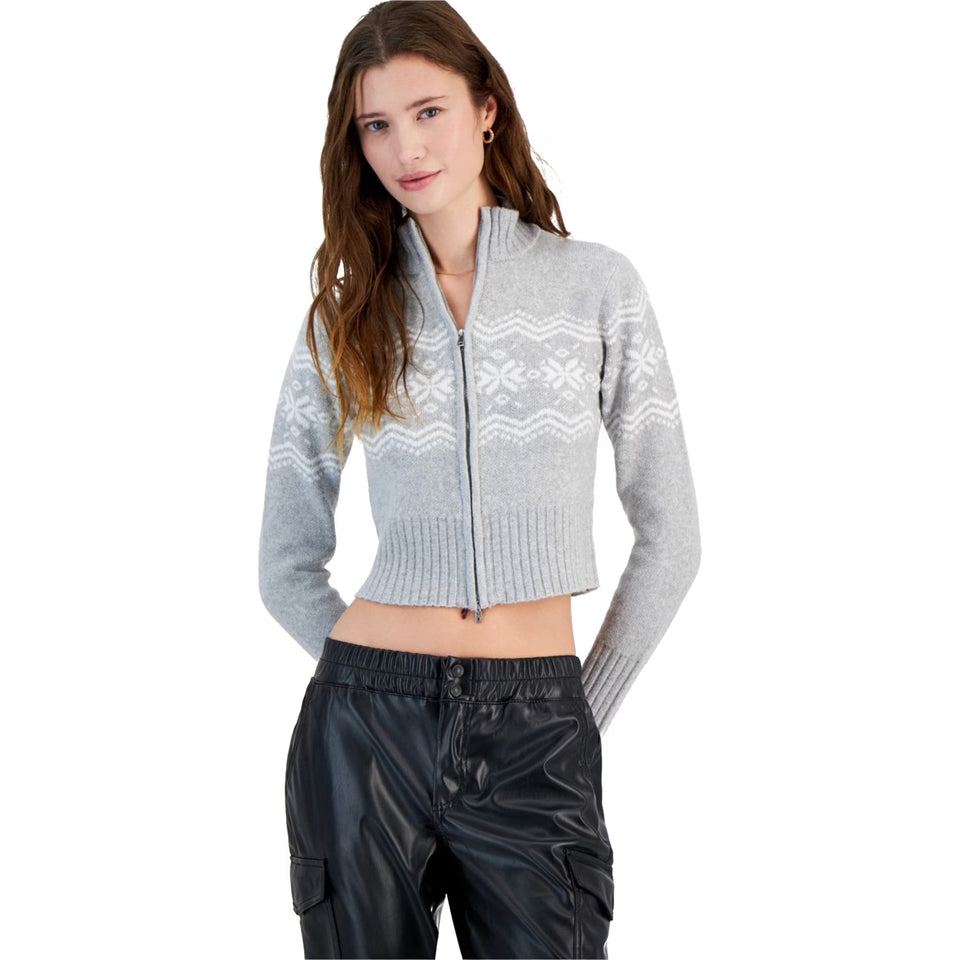 Woman wearing a gray zip-up sweater with a white pattern on a white background