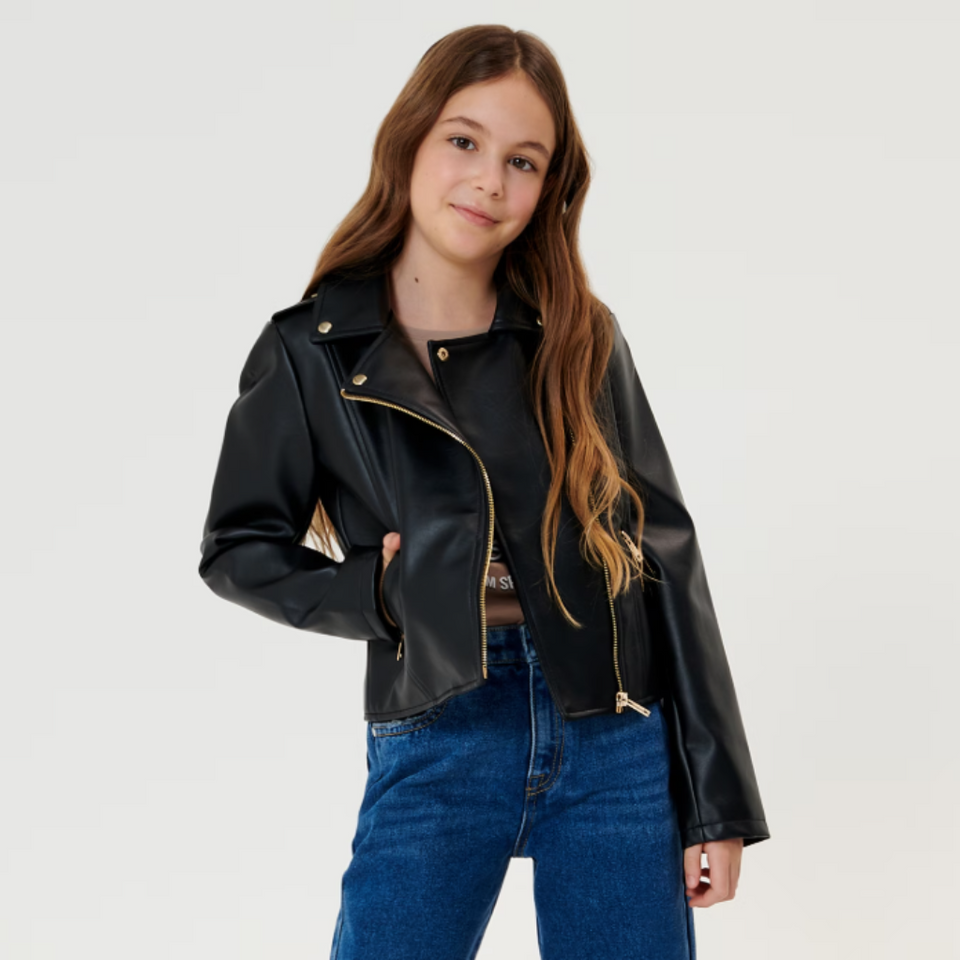Person wearing a black leather jacket and blue jeans on a white background