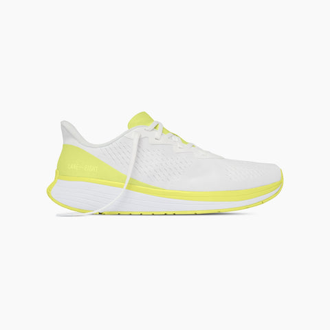 White running shoe with yellow accents on a white background