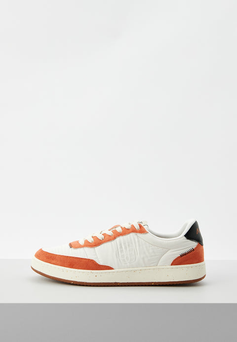 White sneaker with orange accents on a light gray background