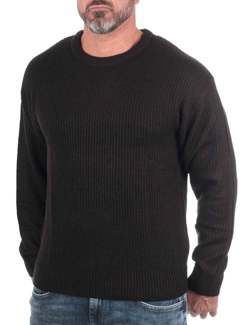 Man wearing a black ribbed sweater on a white background