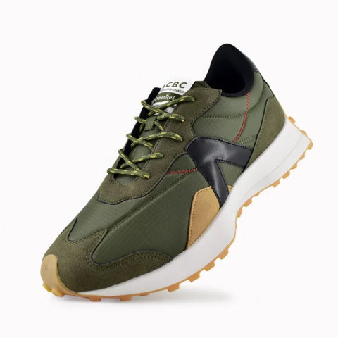 Green sneaker with a white sole on a light gray background