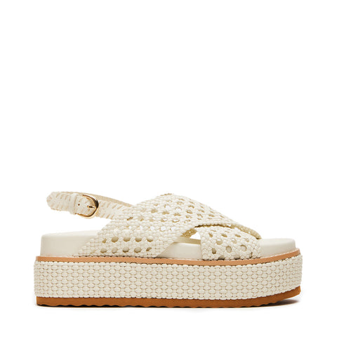 White woven sandal with a brown platform sole on a white background