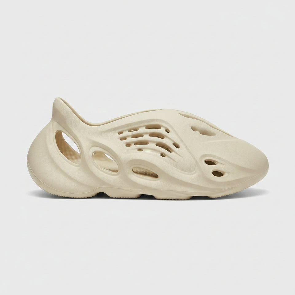 Beige sneaker with unique sole design on a light gray background