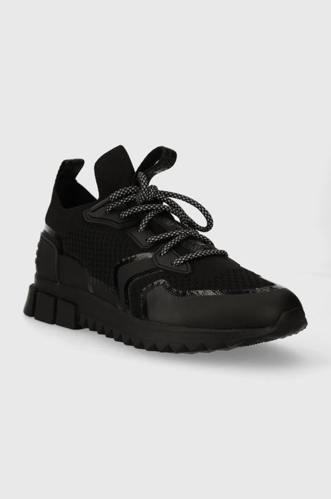 Black sneaker on a light gray background