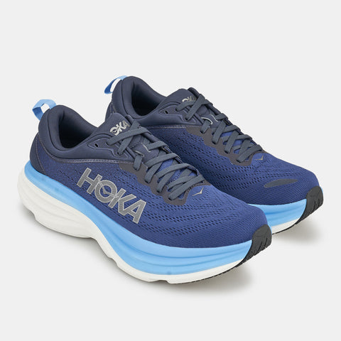 Blue running shoes with white sole on a light gray background