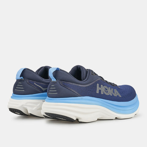 Blue running shoes with white sole on a light gray background