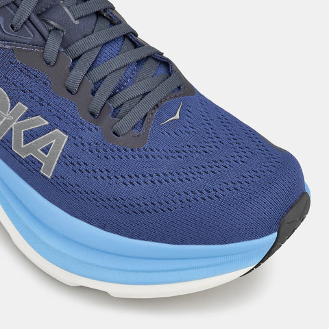 Blue running shoe with visible brand logo on a light gray background