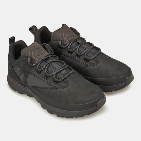 Pair of black sneakers on a light gray background