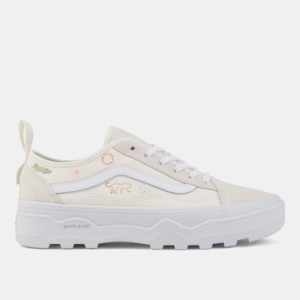 A low-top platform sneaker in off-white canvas with white laces and a thick white waffle sole, featuring small pastel embroidered animal and leaf motifs on the side and heel.