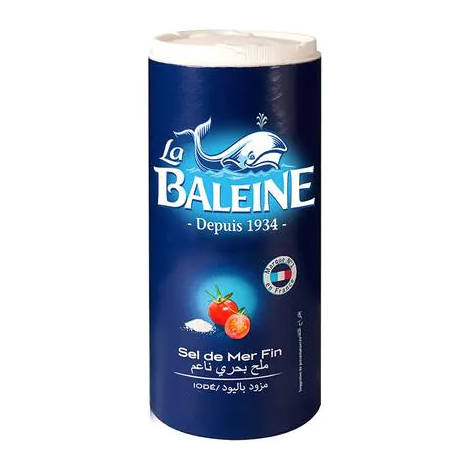 A cylindrical container of La Baleine Fine Sea Salt Iodized with the brand's logo and product information on the label.