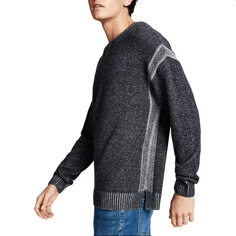 Man wearing a dark gray sweater with patterned sleeves on a white background