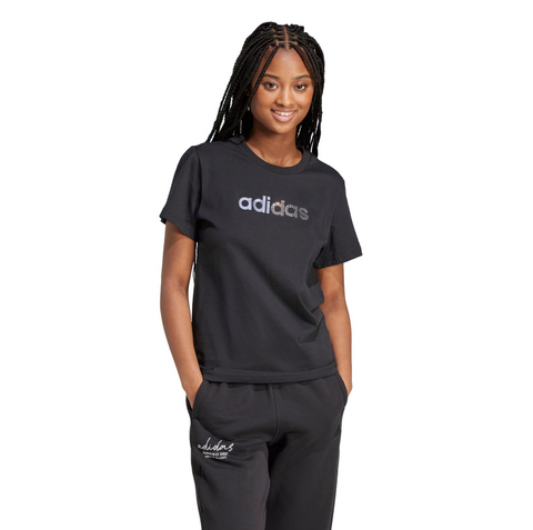 Person wearing an Adidas t-shirt and pants on a white background