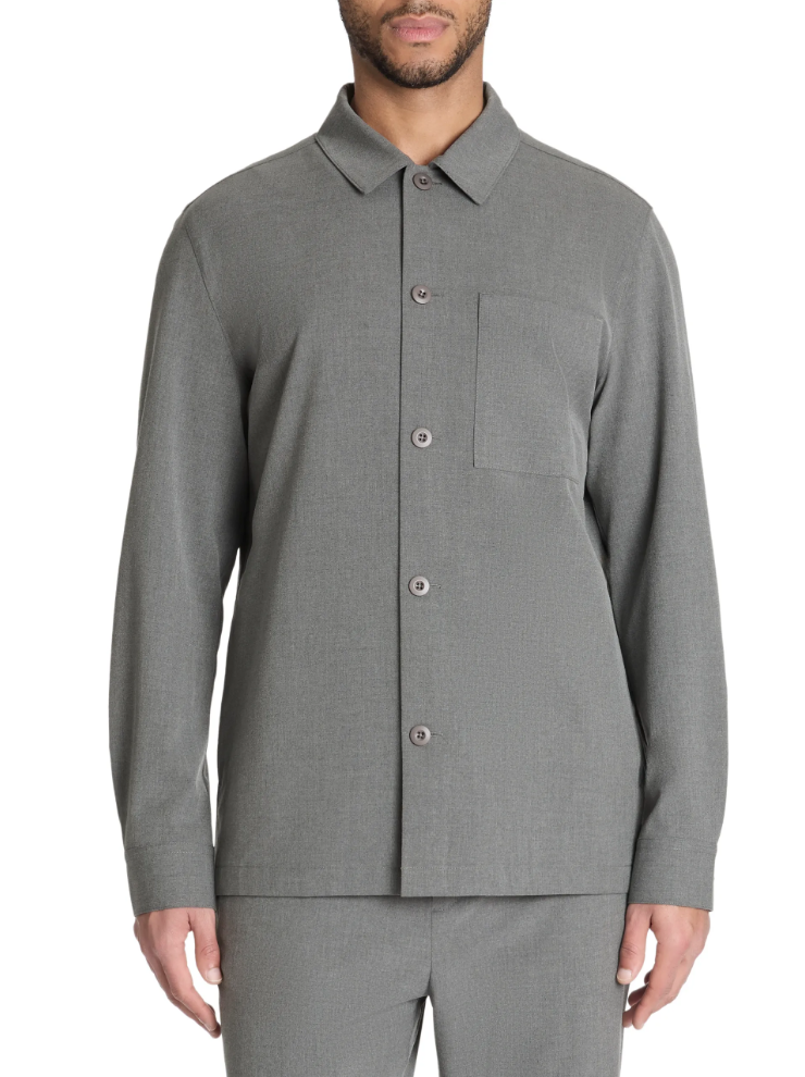 Man wearing a gray button-up shirt with a pocket on a white background