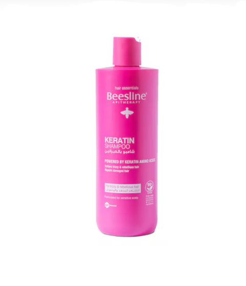 Pink shampoo bottle with 'Beesline' branding on a white background