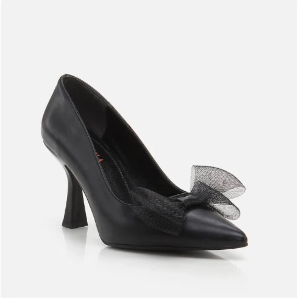 A single black leather high-heeled pump with a pointed toe and a sheer black tulle bow detail on the front, shown against a light gray background.